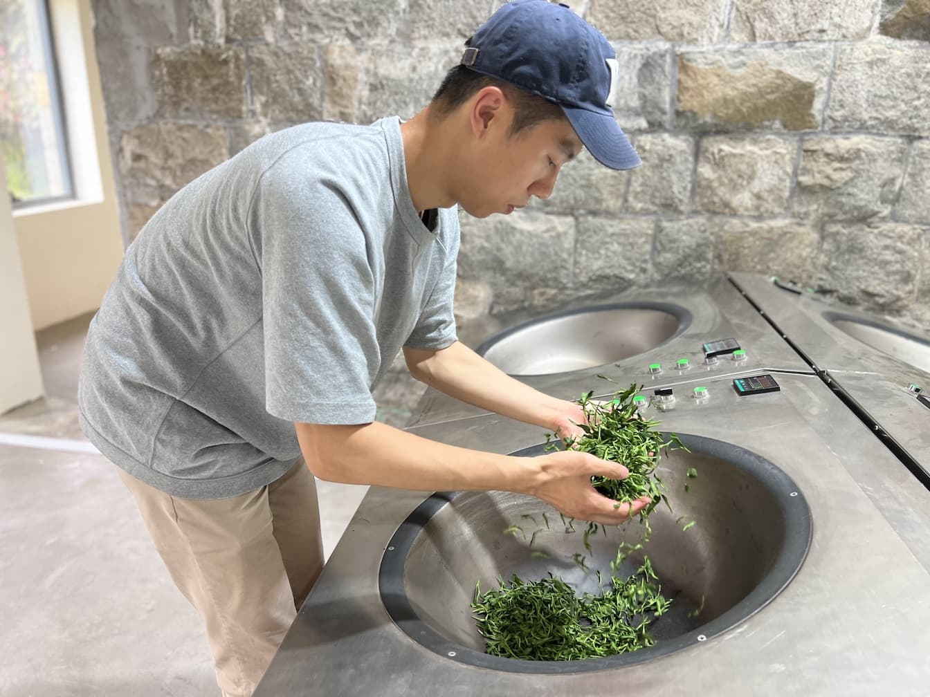 Vincent Liu hand pan-frying tea leaves
